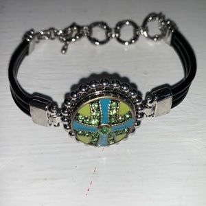 One black embossed leather toggle snap bracelet with one snap.  NWOT